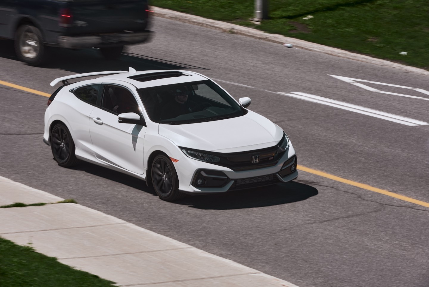 2020 Honda Civic Si Coupe driving down a road